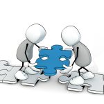 two little sketchy men putting a blue piece of a puzzle at the right place